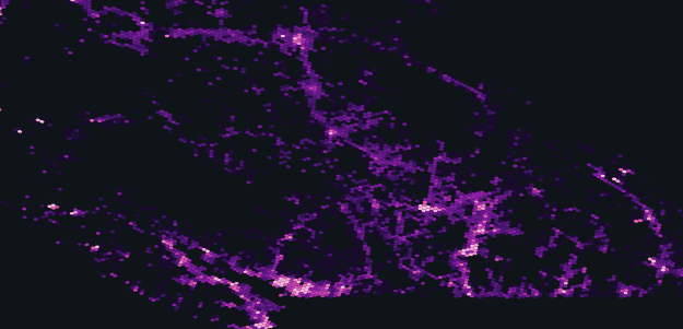 A dark map with scattered purple and pink glowing dots and lines, forming illuminated patterns that resemble streets or networks across the area.
